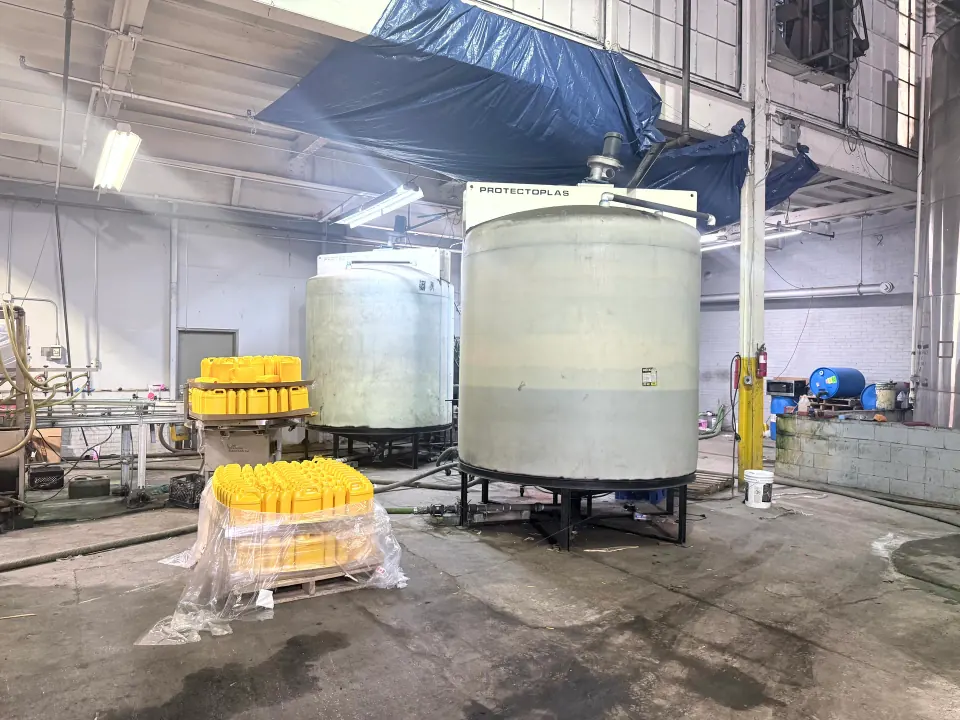 Production tanks beside filled yellow containers