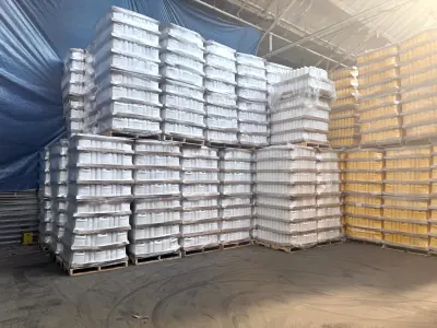 Wrapped pallets of white and yellow one-gallon containers